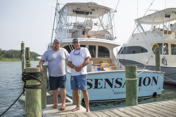 From left, Sensation boat owner Ashley Bleau and captain Greg McCoy stand on the dock in Morehead City, North Carolina, on June 30, 2023. 