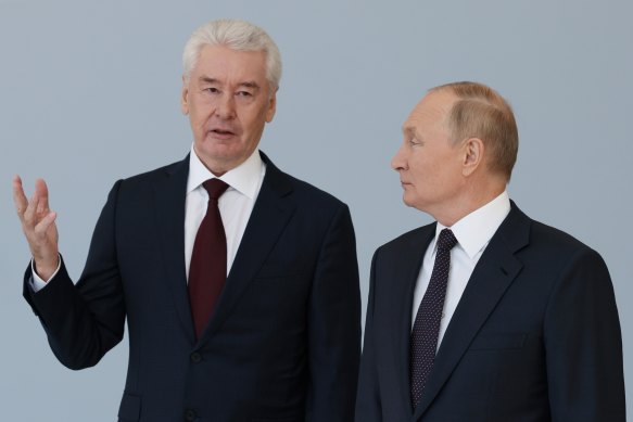 Russian President Vladimir Putin listens to Moscow’s Mayor Sergei Sobyanin as he visits a boxing centre during celebration of the Moscow City Day in Moscow.