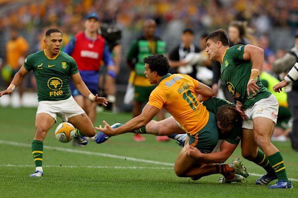 Joseph-Aukuso Suaalii of the Wallabies offloads.