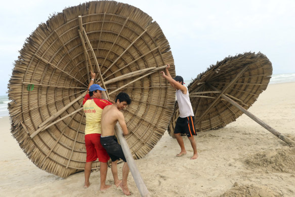People remove beach cabanas ahead of typhoon Molave in Danang, Vietnam. The storm is expected the hit tourism areas hard.