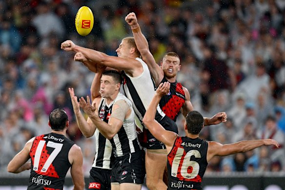 Billy Frampton of the Magpies spoils a mark against Essendon on Anzac Day.