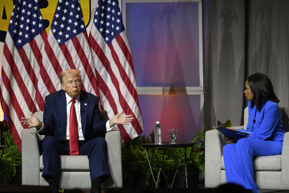 Republican presidential candidate Do<em></em>nald Trump left, participates in a discussion at the Natio<em></em>nal Association of Black Journalists Co<em></em>nvention and Career Fair. On the right is ABC’s Rachel Scott. 