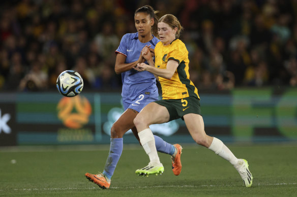 Cortnee Vine battles France’s Maelle Lakrar for the ball.