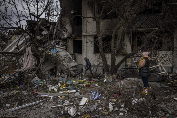 Tanya Hachnikova and Oksana Dikan wait while their husbands attempt to find a way into the basement of a destroyed building in Borodyanka, where Tanya’s parents in law died, along with more than 20 others.