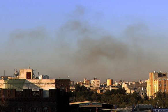 Smoke rises from the area around the international airport in Sanaa after the strikes.