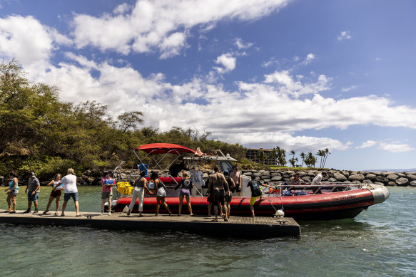 Volunteers load supplies onto a boat for West Maui at the Kihei boat landing, after a wildfire destroyed much of the historical town of Lahaina.
