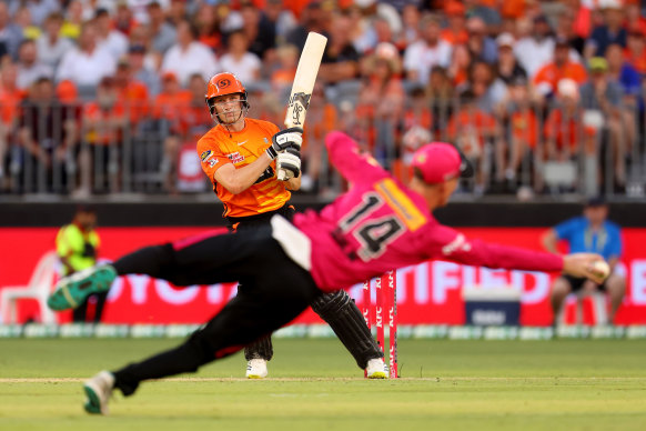 Cameron Bancroft watches as Jordan Silk takes a diving catch.