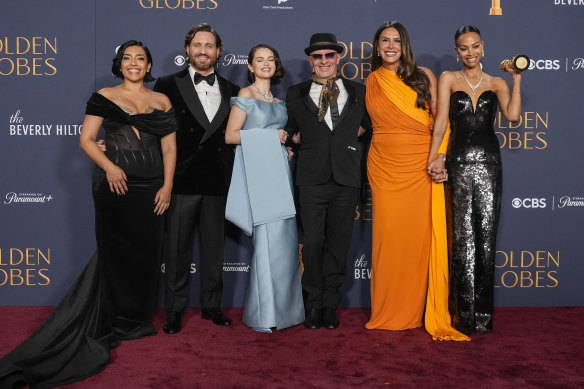 Adriana Paz, from left, Edgar Ramirez, Selena Gomez, Jacques Audiard, Karla Sofia Gascon, and Zoe Saldana  with the award for best motion picture - musical or comedy for Emilia Perez.