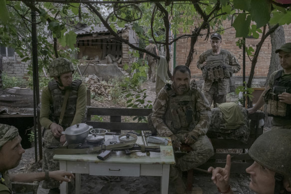 Ukrainian soldiers listen to the whir of a rocket nearby at a frontline position in the Donetsk region of eastern Ukraine.