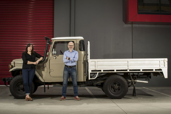 Emma Sutcliffe and EVolution Australia founder Russ Shepherd with a client's 1979 Toyota landcruiser. They have been set the unique challenge of giving it a 500km battery range. 