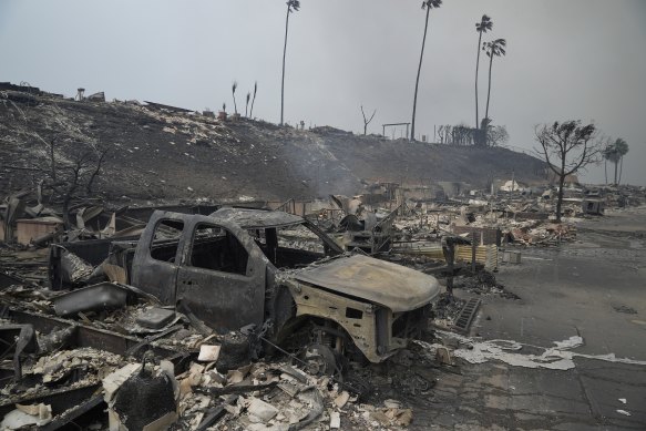 A vehicle and other structures are burned as the Palisades fire ravages a neighbourhood.