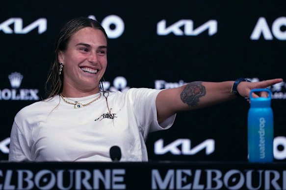 Aryna Sabalenka gestures towards her coaches.