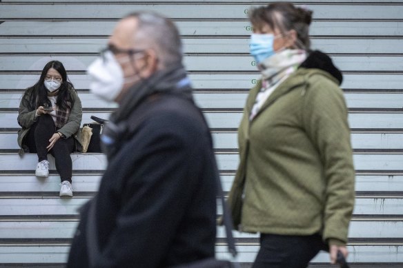 People wearing face masks near Southern Cross station in Melbourne.