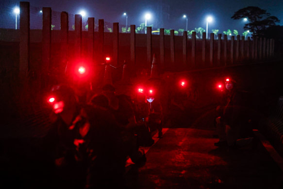 Civil defence group members conduct night-time radio communication, formation and explosive identification exercises simulating attacks by Chinese soldiers, in New Taipei, Taiwan.