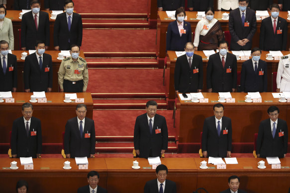 Chinese President Xi Jinping, centre,  and other Chinese leaders stand during the opening session of China's National People's Congress at the Great Hall of the People in Beijing on Friday.
