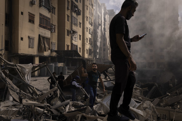 Sorting through rubble in Dahiya, the predominantly Shia southern suburbs of Beirut, after a barrage of Israeli airstrikes.