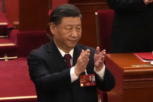 Chinese President Xi Jinping applauds at the closing ceremony for China’s National People’s Congress.