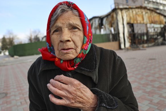 An elderly local resident speaks to a journalist near a destroyed part of the Illich iron and steelworks in Mariupol on Saturday.