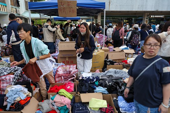 Volunteers help distribute donated clothes to affected residents. 