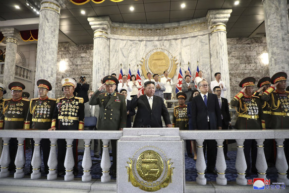 Kim Jong-un (centre) with Sergei Shoigu (to his left) and Li Hongzhong (right) at the military parade in Pyongyang on Thursday.