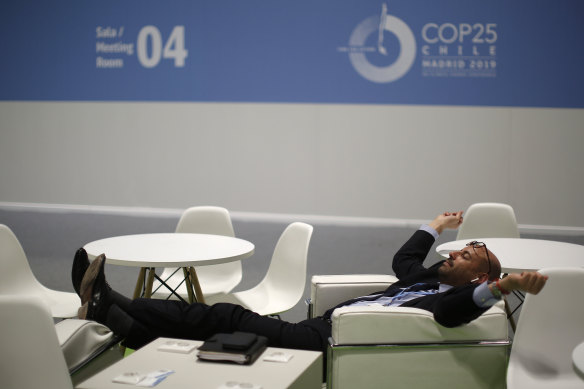 Exhausted: a delegate takes a break during the UN climate talks in Madrid. 