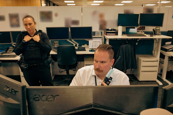     Detective Senior Sergeant Stacey Dwyer and Acting Detective Sergeant Maxwell Slarke watch the AirWing broadcast at Sunshine police station.