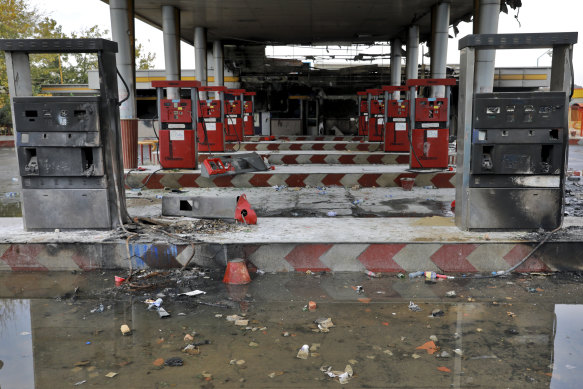 Rainwater pools at a gas station attacked during protests over government-set gasoline prices in Tehran, Iran. 