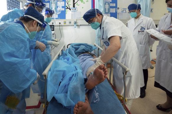 Medical workers check the health condition of Gan Yu, a hydropower station worker who had gone missing for 17 days after an earthquake.