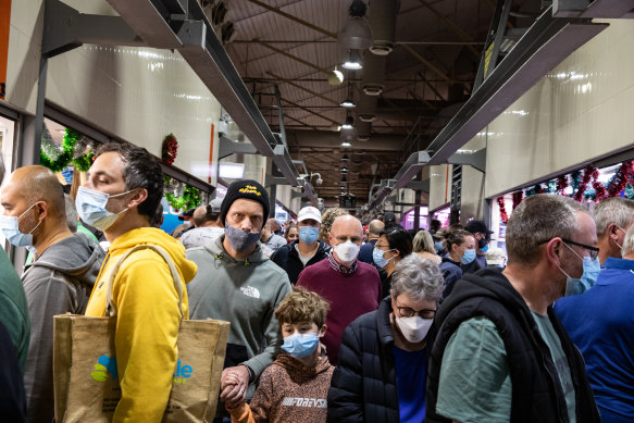 Melburnians wear face masks as they shop at the Queen Victoria Market.