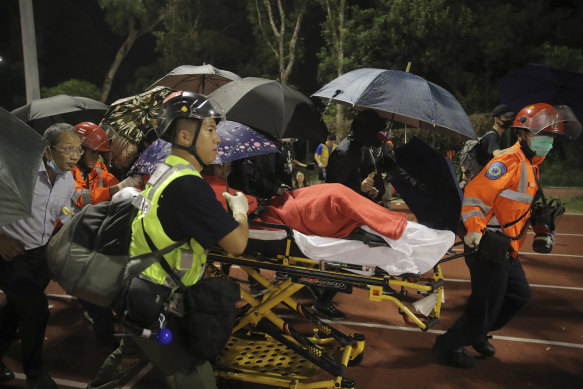 Medical workers move an injured student following clashes with police at the Chinese University in Hong Kong.