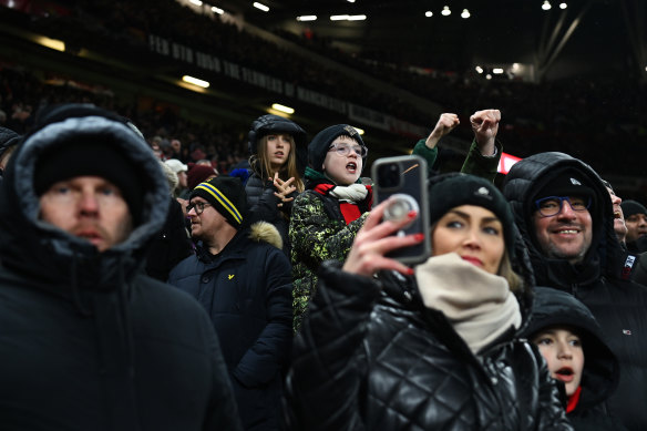 Fans of Manchester United enjoy a match at Old Trafford.