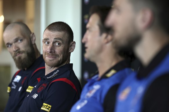 Demons coach Simon Goodwin looks on as Bulldogs counterpart Luke Beveridge speaks to the media before last year’s grand final.