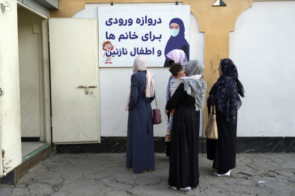 Afghan women stand outside an amusement park, in Kabul, Afghanistan, on Thursday.