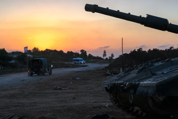 Tanks are seen in a staging area during sunset near the border of Northern Gaza.;