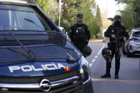 Police officers stand guard as they cordon off the area next to the Ukrainian embassy in Madrid, Spain.