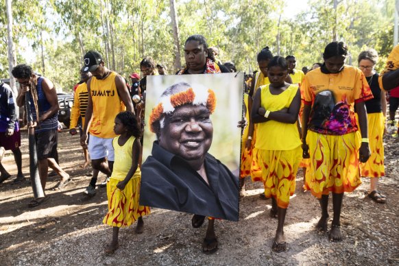 Warrana Marika clutched a portrait of Dr Yunupingu as the family walked through the crowd.