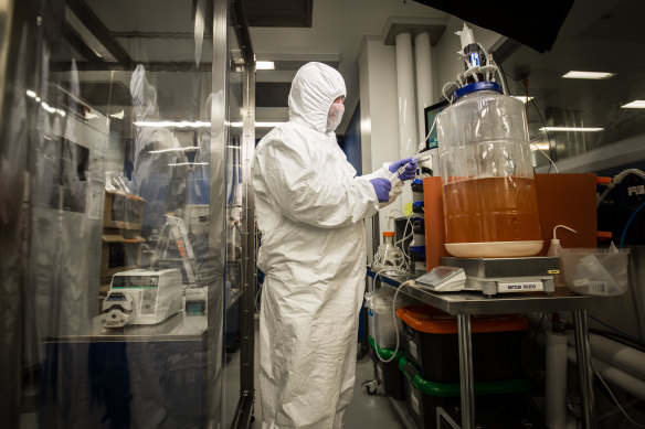 Professor George Lovrecz with a fermenter where vaccine proteins will be grown.