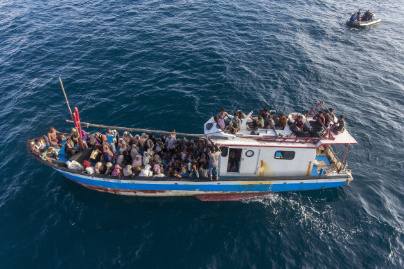 A boat carries ethnic Rohingya off North Aceh, Indonesia, on June 24.