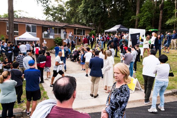 A crowd of about 100 people gathered to watch the nine properties go under the hammer on Thursday afternoon.