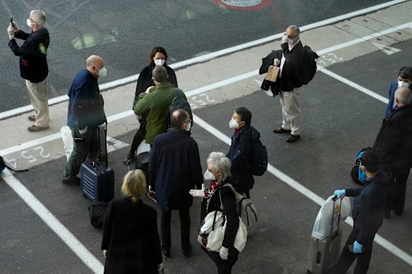 Members of the World Health Organization (WHO) team gather after arriving at the airport in Wuhan in central China's Hubei province on Thursday, January 14, 2021.