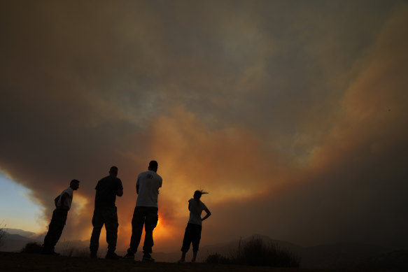 Residents of villages watch a fire in the Larnaca mountain region of Cyprus on Saturday.