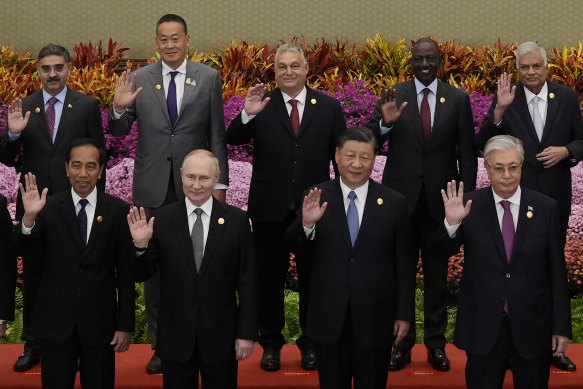 From left in front row: Indonesian President Joko Widodo, Putin, Xi and Kazakhstan President Kassym-Jomart Tokayev with other leaders wave during a group photo session at the Belt and Road Forum in Beijing.