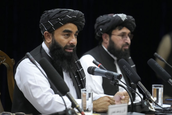 Zabiullah Mujahid, left, the spokesman for the Taliban government, speaks during a press conference in Kabulon June 30.