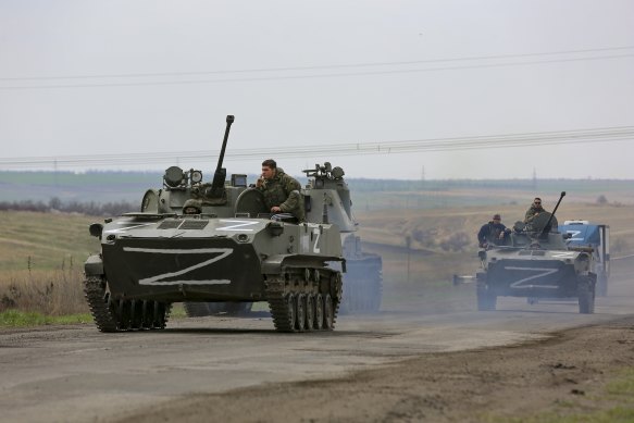 Russian military vehicles move on a highway in an area controlled by Russian-backed separatist forces near Mariupol, Ukraine.