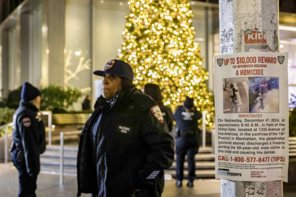 A poster advertising a reward for information is posted near the site where Brian Thompson, chief executive of UnitedHealthcare, was fatally gunned down in midtown Manhattan.