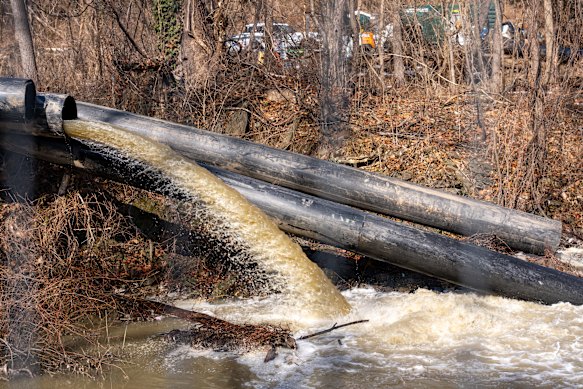 Sewage water is pumped into a canal as a temporary bypass for a broken segment of the Potomac Interceptor sewage pipe, near Cabin John, Maryland.