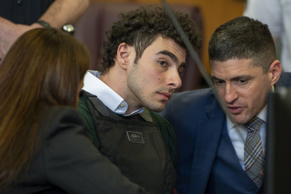 Luigi Mangione, accused of fatally shooting the UnitedHealthcare chief executive Brian Thompson in New York, confers with his attorney during a court hearing.