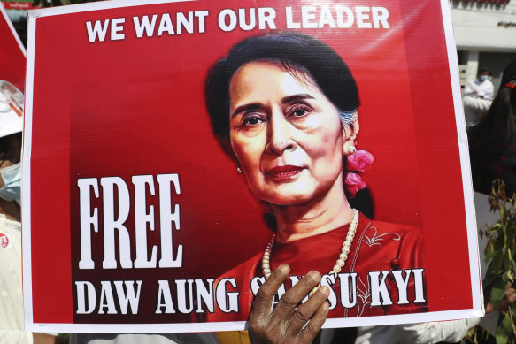 A protester holds a sign demanding Myanmar’s elected civilian leader Aung San Suu Kyi be freed.
