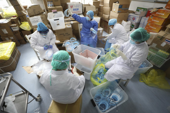 Nurses assemble plastic face shields at a hospital designated for the coronavirus patients in Wuhan.