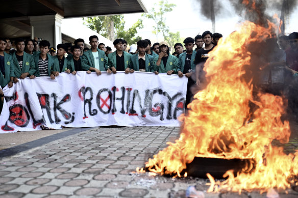 Demonstrators burn tyres at a protest rejecting Rohingya refugees in Banda Aceh, Indonesia, on December 27.